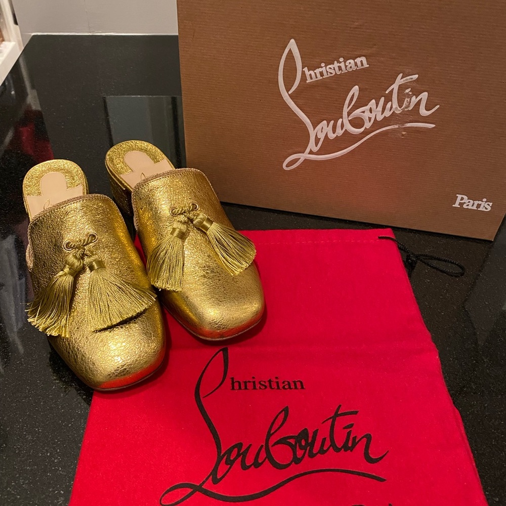 Gold Louboutin mules with tassels
